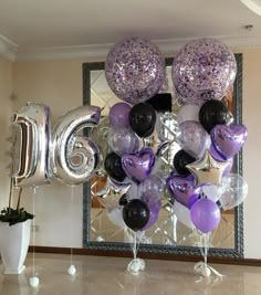 balloons and streamers are arranged in the shape of the letter g for an anniversary celebration