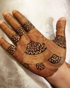 the hand is decorated with intricate designs on it