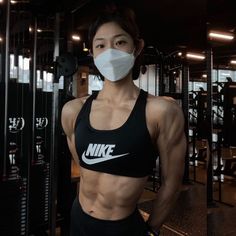 a woman wearing a face mask in a gym