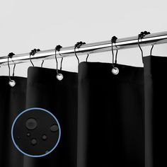 a black curtain with blue circles hanging from it's metal rod and two lights on each side