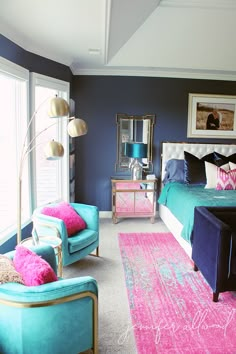 a bedroom with blue walls and pink rugs on the floor next to two chairs