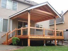 a house with a covered porch in the front yard