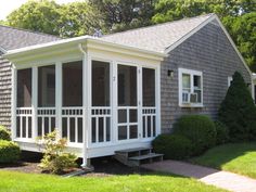 a small house with screened porch and windows