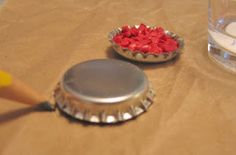 two empty bottle caps sitting on top of a table