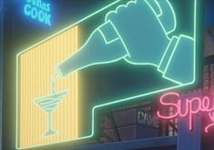 a neon sign that says sushi's cook on the side of a building