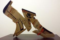 a sculpture made out of cardboard sitting on top of a table