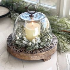 a candle that is sitting inside of a glass dome