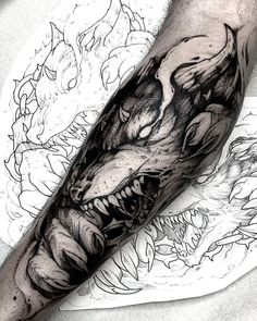 a black and white photo of a dragon tattoo on the arm, done by an artist