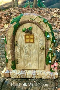 a small wooden door with vines and flowers on the outside, in front of some leaves