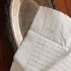 two pieces of paper sitting on top of a silver tray