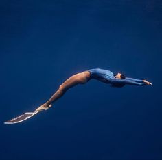 a woman is diving in the water