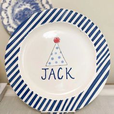 a blue and white striped plate with a birthday hat on it's side that says, jack