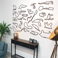 a living room with a couch, table and chair in front of a wall sculpture