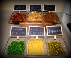 several different types of food are on display in plastic containers with signs that read green onions, shredded cheese and jalapenos