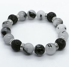 Lava beads are perfect for aromatherapy use. Volcanic rock works like a natural diffuser, emitting an aroma of whatever this porous material will absorb! Directions for aromatherapy uses: Make best use of it by dabbing on your favorite essential oil(s) on these bead(s) with a Q-Tip or cotton ball for best results. This Aromatherapy bracelet can be used as a natural diffuser for your essential oils, perfume, body spray, or simply just worn for the look for it! Note: Please do not get your lava be Boy Bracelets, Essential Oils Perfume, Lava Bead Bracelet, Aromatherapy Bracelet, Perfume Body Spray, Tourmalinated Quartz, Lava Bracelet, Bracelets Design, Astral Projection