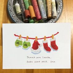 some crayons are sitting on a table and there is a card that says thank you santa take some rest, dan