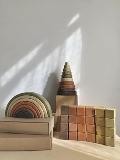 a stack of different colored tiles sitting on top of a table next to each other