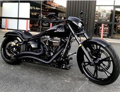 a black motorcycle parked in front of a building