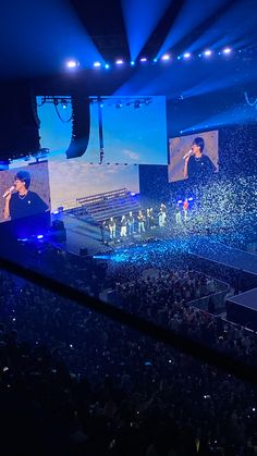 the stage is lit up with confetti as people watch