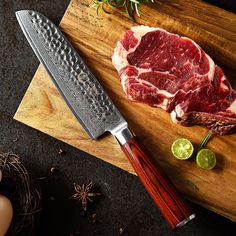 a piece of meat sitting on top of a cutting board next to a knife