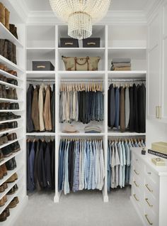 an organized closet with white shelving and lots of clothes on shelves, including shoes