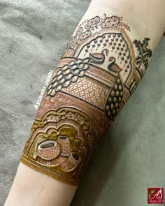 a woman's arm covered in henna