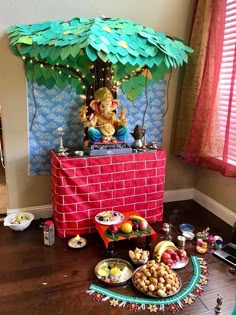 there is a table with food on it in the middle of the room and an elephant statue