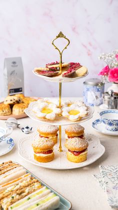 three tiered trays filled with pastries on top of a table