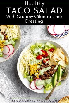 two bowls filled with taco salad and topped with corn, lettuce, radishes