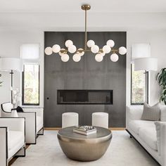 a modern living room with white furniture and large chandelier hanging from the ceiling