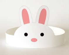 a white paper bunny headband with pink ears