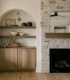 a living room filled with furniture and a fire place in front of a brick fireplace