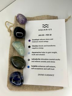 some rocks are sitting on top of a piece of paper with the words aquarius written in it