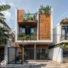 an apartment building with plants on the balconies