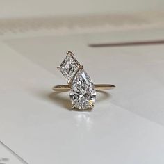 an engagement ring with two pear shaped diamonds