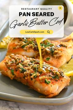 pan seared garlic butter salmon on a plate with lemon wedges