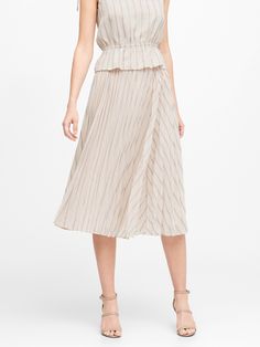 The perfect piece to wake up your wardrobe, this midi skirt has intricate knife pleats that radiate out from the waistband.  Plus, it's made with our customer-favorite Soft Satin fabric that's also easy to care for.  Side zip.  Fully lined.  High wai Pleated Flared Skirt Midi Dress, Pleated Midi Dress With Voluminous Skirt, Spring Flowy Pleated Skirt, Summer Dress With Accordion Pleats, Spring Voluminous Pleated Skirt With Elastic Waistband, Spring Daywear Pleated Tiered Skirt, Voluminous Pleated Midi Skirt For Summer, Spring Flowy Skirt With Pleated Hem, Spring Flared Skirt Dress With Accordion Pleats