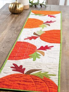 a table runner with pumpkins on it