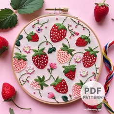 an embroidery project with strawberries and flowers on it