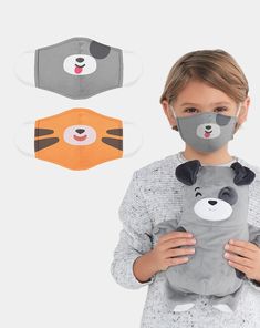 a child wearing a face mask and holding a stuffed animal