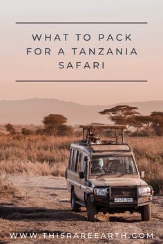 an suv driving down a dirt road with the words what to pack for a tanzania safari