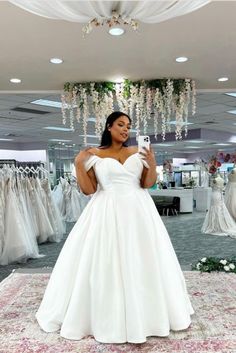 a woman is taking a selfie in her wedding dress