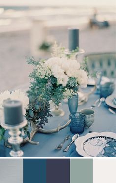 the table is set with blue and white flowers