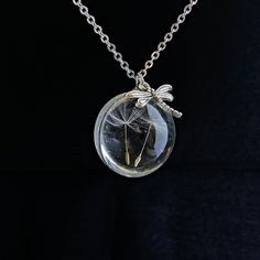 Two dandelion seeds in a glass sphere necklace  This necklace features a small (25mm) solid glass orb with one single real two dandelion seeds inside. The length of the chain 24 inches- 3 mm Diameter with a lobster clasp closure. A great gift idea for anyone you think might need some luck or a wish!  Dandelion jewelry: https://www.etsy.com/shop/NewJewelleryStory?ref=seller-platform-mcnav&section_id=22403224 https://www.etsy.com/listing/565668287/dandelion-necklace-real-dandelion?ref=shop_home_ac Sphere Jewelry, Dandelion Jewelry, Wish Dandelion, Sphere Necklace, Uncommon Gifts, Dandelion Necklace, Dandelion Seeds, Inexpensive Jewelry, Glass Orb