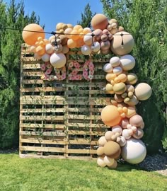 a wooden pallet with balloons attached to it in the shape of letters and numbers