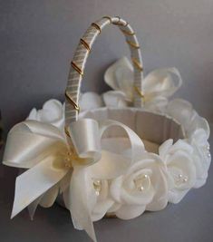 a white basket with flowers on it