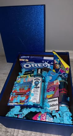 a blue box filled with lots of different types of candy and confection items