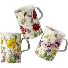 three coffee mugs with flowers painted on them