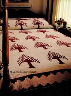 a bed with two quilts on it in a bedroom