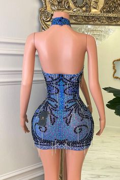 a mannequin is standing in front of a mirror wearing a blue dress with beadings